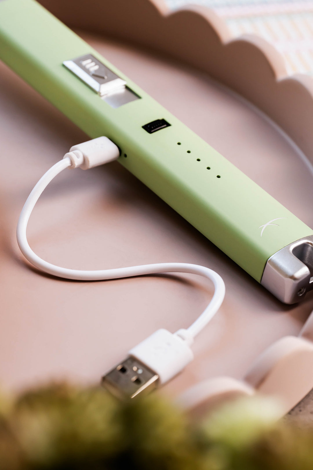 Sizzle Pitmaster USB rechargeable lighter in Aloe color with white USB charge cord inserted